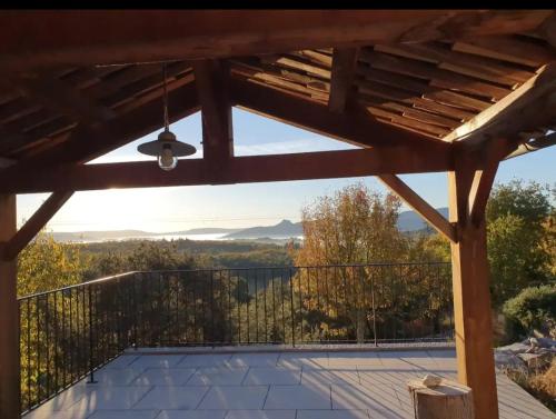 a view from the deck of a house with a pergola at Le Trible in Labeaume