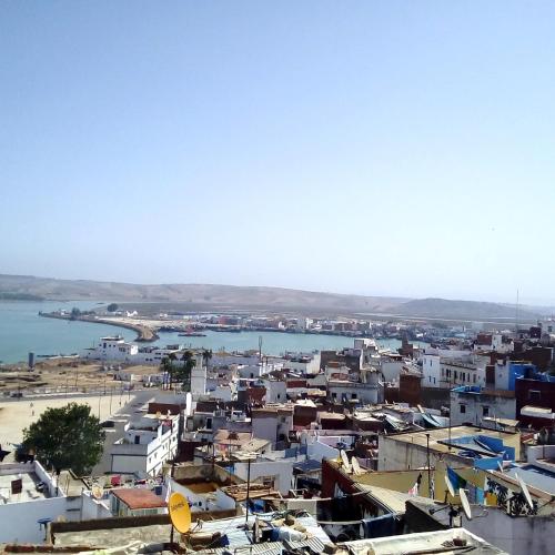 a city with buildings and a body of water at Riad Larache in Larache