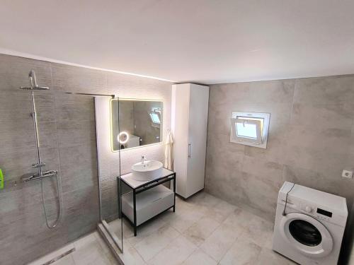 a bathroom with a shower and a sink and a toilet at Glyki Canyon Bungalow in Antimácheia