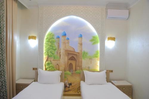 two beds in a room with a painting on the wall at Turon Khiva in Khiva