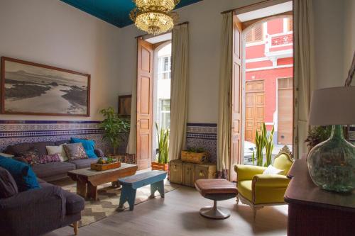 a living room filled with furniture and a large window at Aminta Home in Las Palmas de Gran Canaria
