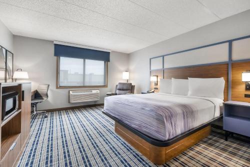 a hotel room with a bed and a television at AmericInn by Wyndham Bismarck in Bismarck