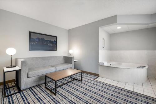 a living room with a couch and a bath tub at AmericInn by Wyndham Bismarck in Bismarck