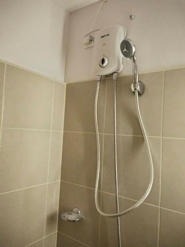 a shower with a shower head in a bathroom at Clover88 Studio Room is in the City but with a seaview in Mandaue City