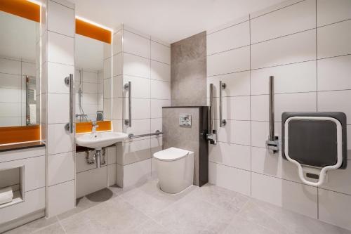 a bathroom with a toilet and a sink at Hyatt Place Leeds in Leeds