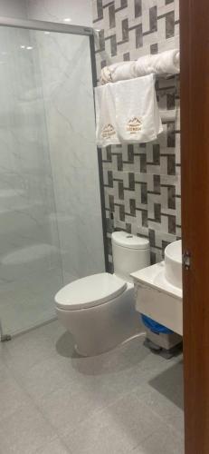 a bathroom with a toilet and a sink and a shower at Hải Nam Hotel Tây Ninh in Tây Ninh