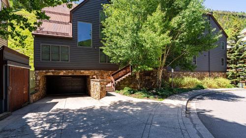 a black house with a garage and a driveway at Etta Place 1 by AvantStay Ski In Ski Out Unit w Views of the Slopes in Telluride