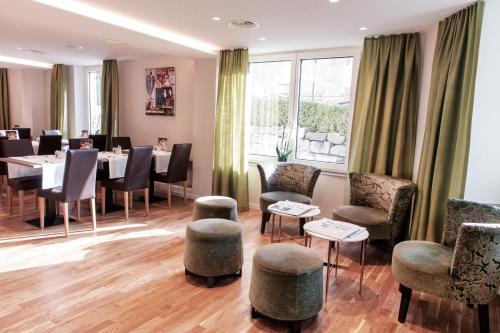 a dining room with a table and chairs at Sorell Hotel Rex Zürich in Zurich