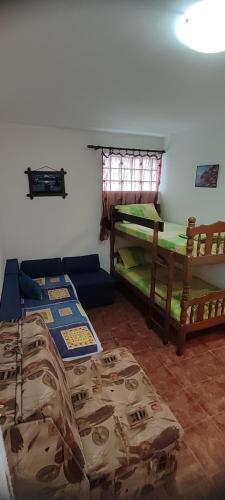 a room with two beds and a couch in it at Apartman Jasna in Herceg-Novi
