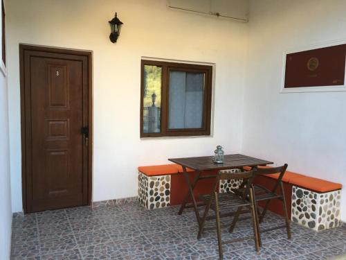 a room with a table and chairs and a door at Triton Apartments in Nea Skioni