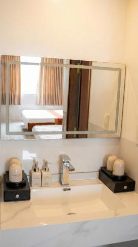 a bathroom with a sink and a mirror at Khách Sạn Ngọc Châu in Lấp Vò