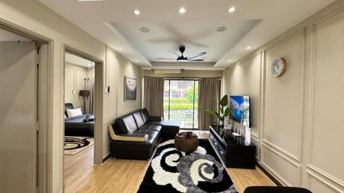 a living room with a couch and a tv at Ayu Blue Lagoon PD by GPH in Port Dickson