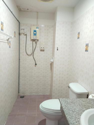 a bathroom with a shower with a toilet and a sink at Krabi Hotel Agency in Krabi
