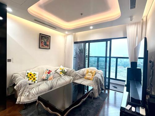 a living room with a couch with pillows on it at Hanaco Homestay in Hai Phong
