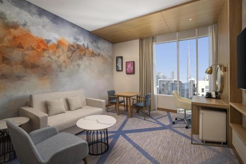 a living room with a couch and chairs at Hilton Garden Inn Dubai Business Bay in Dubai