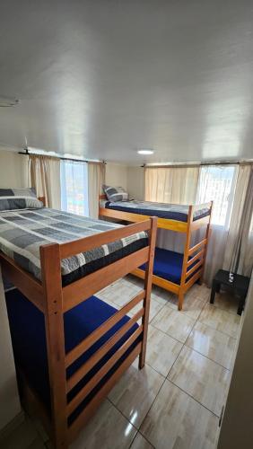 a bedroom with two bunk beds in a house at Apartamentos Santiago Centro R&M in Santiago