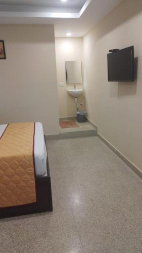 a bedroom with a bed and a toilet in a room at AB Residency in Chennai