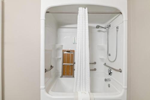 a white bathroom with a shower and a bath tub at Park Inn by Radisson, Grand Island I-80 in Grand Island
