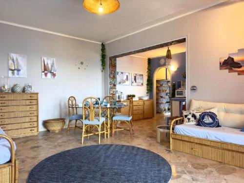 a bedroom with a bed and a table and chairs at Sicily Sea Villa Capo Zafferano in Santa Flavia