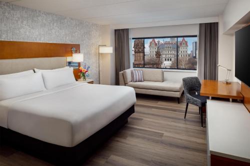 a hotel room with a bed and a desk at Hilton Albany in Albany