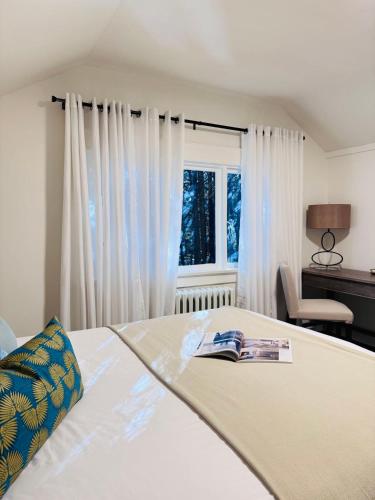 a bedroom with a bed with a book on it at Modern Queen Room Ensuite Bathroom Vancouver West in Vancouver