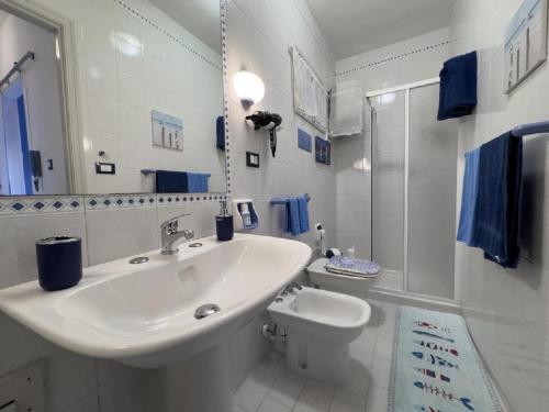 a white bathroom with a sink and a toilet at Sicily Sea Villa Capo Zafferano in Santa Flavia