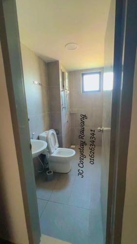 a bathroom with a toilet and a sink at JC COZYsTAY RAWANG in Rawang