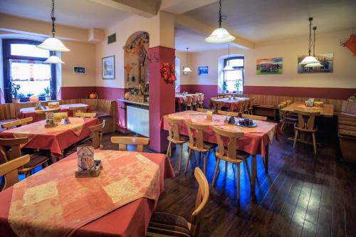 a restaurant with tables and chairs in a room at Gasthaus Krone in Pforzheim