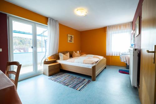a bedroom with a bed and a large window at Gasthaus Krone in Pforzheim
