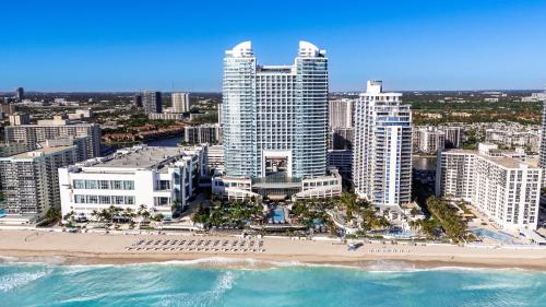 an aerial view of a beach in front of a city at The Diplomat Beach Resort Hollywood, Curio Collection by Hilton in Hollywood