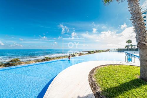 Beachfront Bliss apt, with heated pool, by OYOOSTAYS