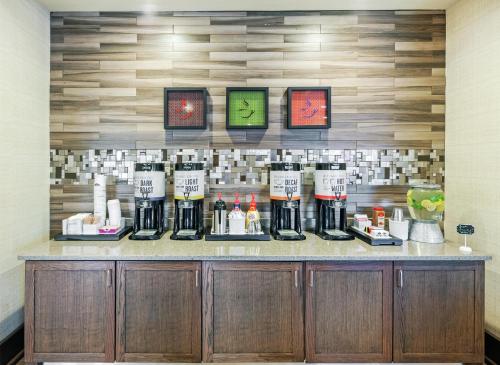 a counter with a bunch of alcohol bottles on it at Hampton Inn North Little Rock McCain Mall, AR in North Little Rock
