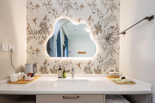 a bathroom with a sink and a mirror at LeD Courtyard Homest ay乐东小院民宿 in Beijing
