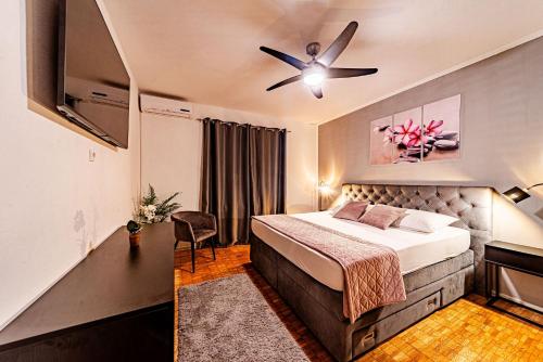 a bedroom with a bed and a ceiling fan at Stella apartment in Korčula