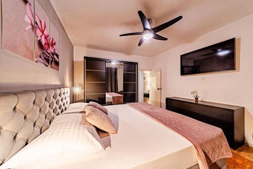 a bedroom with a bed and a ceiling fan at Stella apartment in Korčula