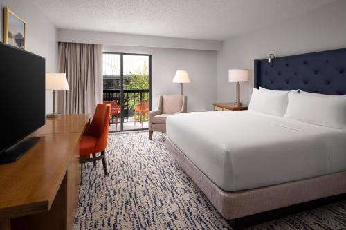a hotel room with a large bed and a television at DoubleTree by Hilton Gainesville in Gainesville