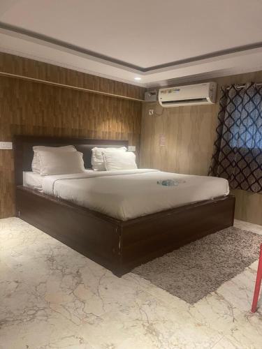 a bedroom with a large bed in a room at Coromandel Suites in Chennai