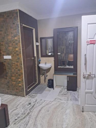 a bathroom with a sink and a shower and a sink at Coromandel Suites in Chennai