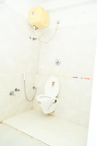 a bathroom with a toilet and a shower at Maurya Royal in Sasarām