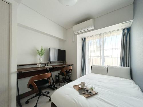 a room with a bed and a desk and a computer at Brilliant MK- III in Tokyo