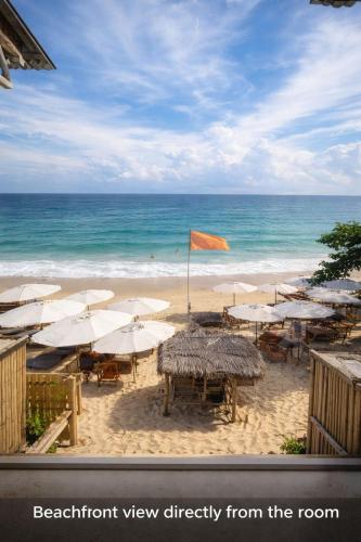 a view of a beach with umbrellas and the ocean at Noahs Ark Beachfront in Lamai