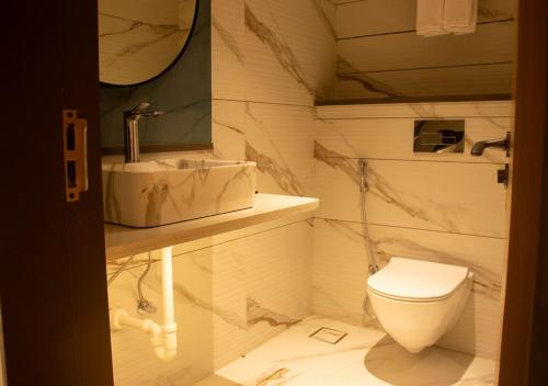 a bathroom with a sink and a toilet at Magnus Lxia Premier, Kalyani Nagar Pune in Pune