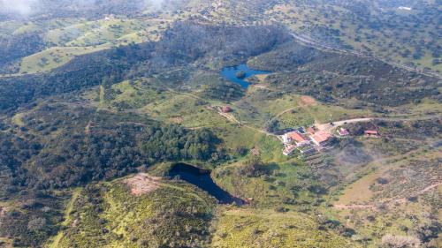 an aerial view of a mountain with a house on it at Quinta Marugo Retreats in Serpa