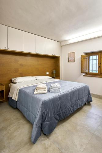 a bedroom with a large bed with a blue blanket at Casa Vicky in Città di Castello
