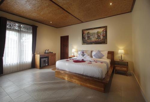 a bedroom with a bed and a large window at Selau Asry in Sidemen