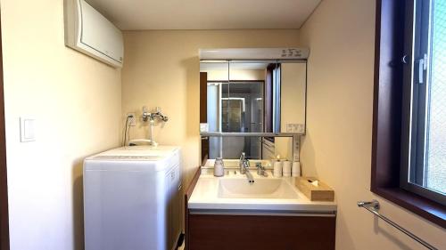 a small bathroom with a sink and a refrigerator at kamakura retreatB in Kamakura