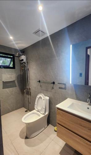 a bathroom with a toilet and a sink at Solunara Malolos in Malolos