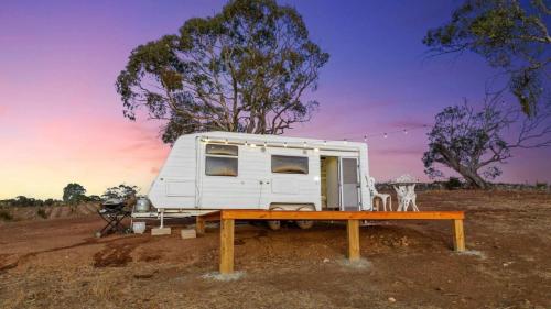 a white trailer sitting on top of a table at Vineyard Farmstay in Clare