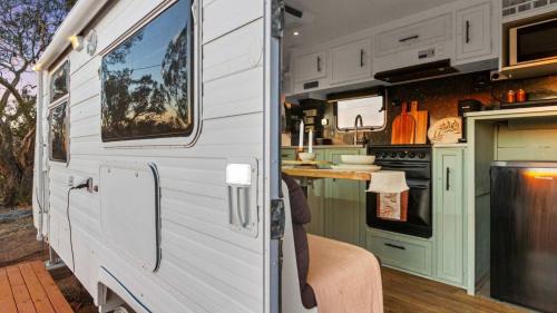 an interior view of an rv with a kitchen at Vineyard Farmstay in Clare