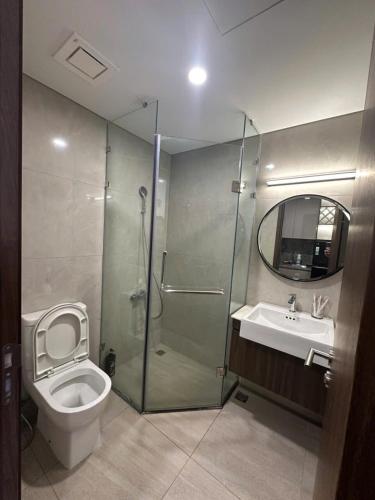 a bathroom with a shower and a toilet and a sink at M2 Homestay vinhomes ocean in Gia Lâm Pho